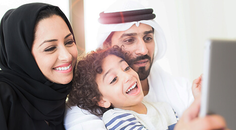 Arab family play together on i pad